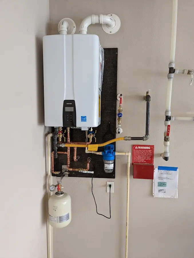 Professional plumber installing copper piping in a Park Hills home